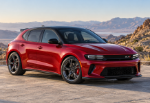 Dodge GLH Revival: Can Dodge Bring Back the Hot Hatch? Concept illustration of a red Dodge GLH-inspired five-door hatchback with a black roof, shown from the front three-quarter angle.